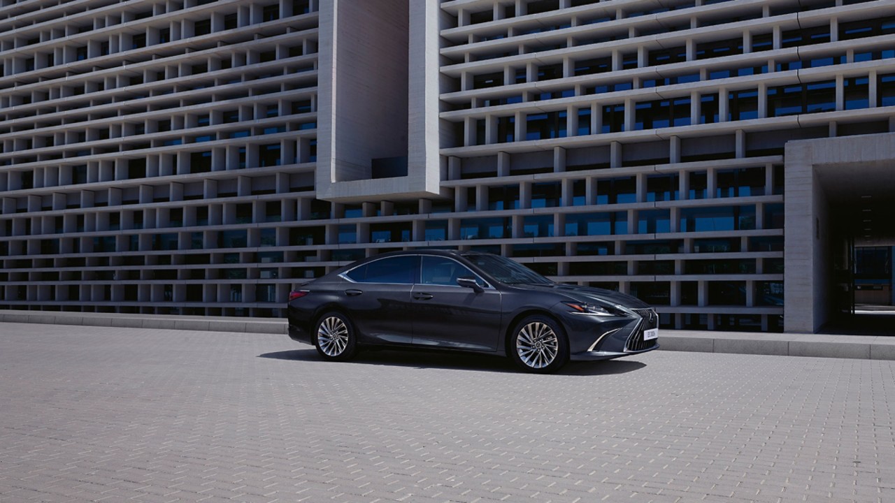 A black Lexus ES 300h driving on a road